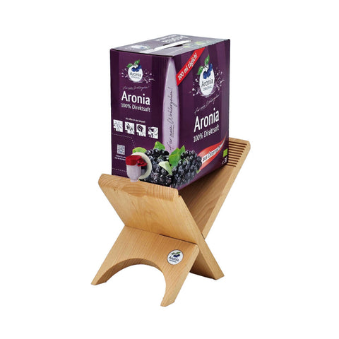 Aronia-Direktsaft Bag-in-Box auf Holzständer, lila Verpackung mit Störer 100 ml täglich, aus Österreich.